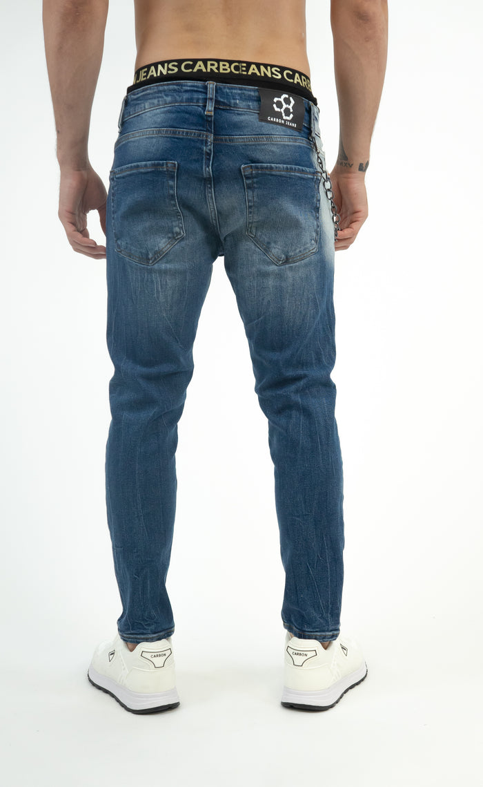 Back view of Andy Blue Washed Jeans for men featuring slim fit denim with distressing, a metal chain, and logo back patch.