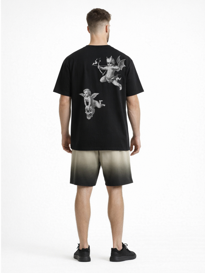 A person wearing a black t-shirt with artistic angel and devil graphics on the back, paired with gradient shorts.
