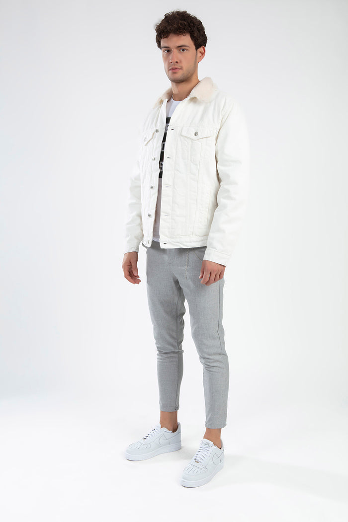 Model wearing the Ashton White Denim Jacket with faux-fur collar and gray pants in a Gen Z urban streetwear style.