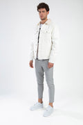 Model wearing the Ashton White Denim Jacket with faux-fur collar and gray pants in a Gen Z urban streetwear style.