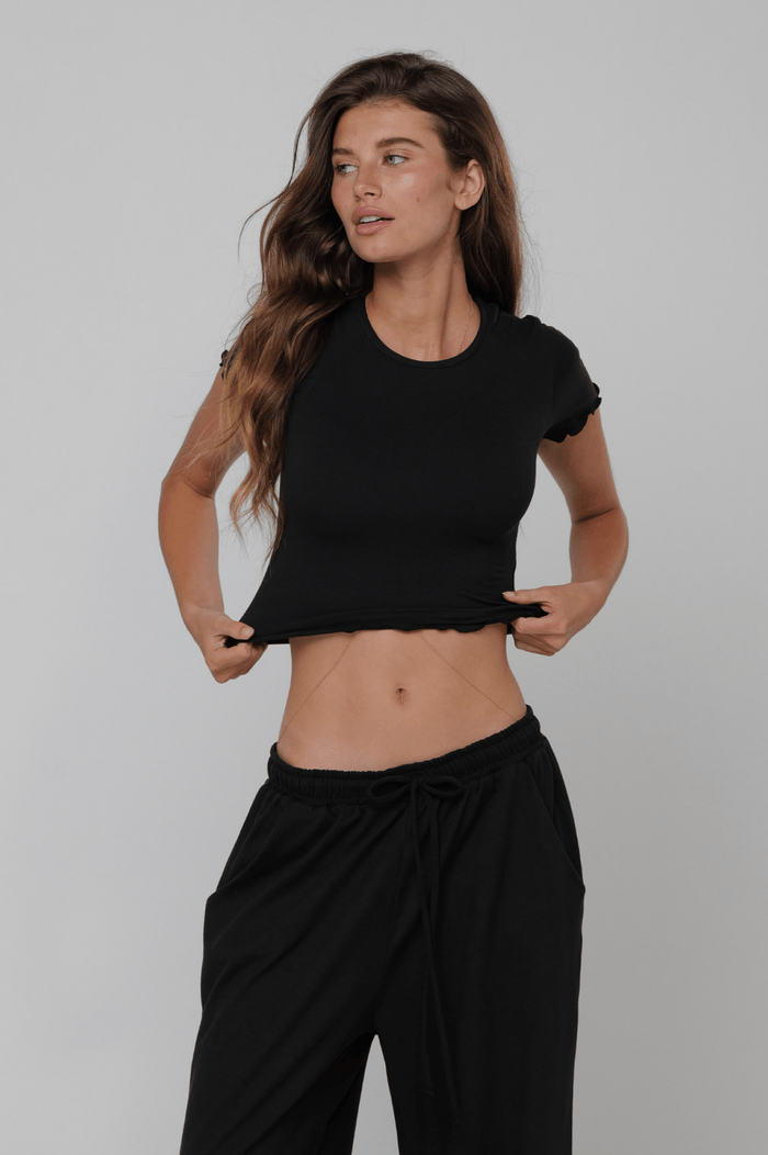 This is an image of Baby Tee Second Skin in Black - RESA featuring a model wearing the dress
