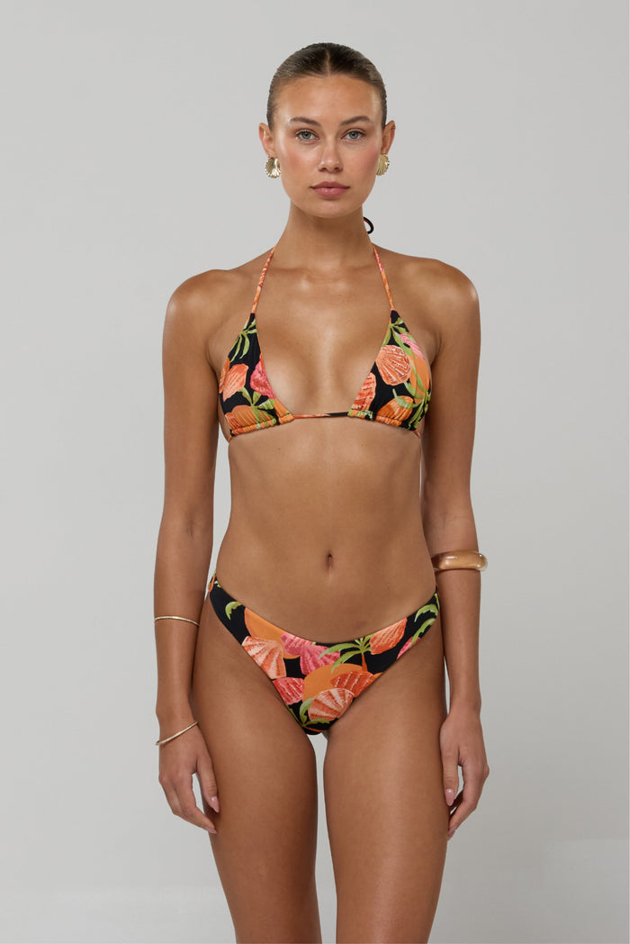 This is an image of Beau Bikini Bottom in Conch - RESA featuring a model wearing the dress