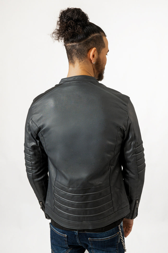 Back view of Bradley black leather jacket with ribbed shoulder and hem detailing on model in blue jeans.
