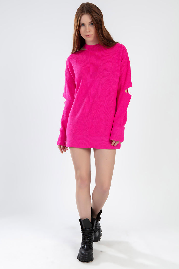 Model wearing the Brooke hot pink oversized knit sweater with trendy shoulder cut-outs and a mock neck.