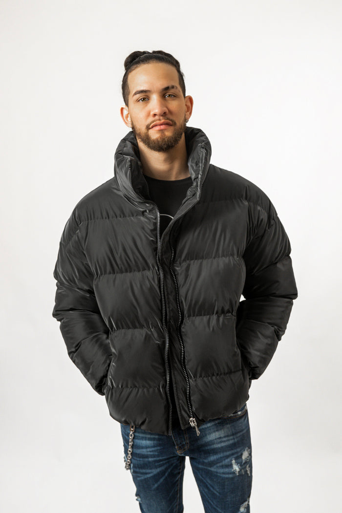 Model wearing the Brooks Black Puffer Coat, a trendy oversized winter jacket with a high collar and quilted texture.