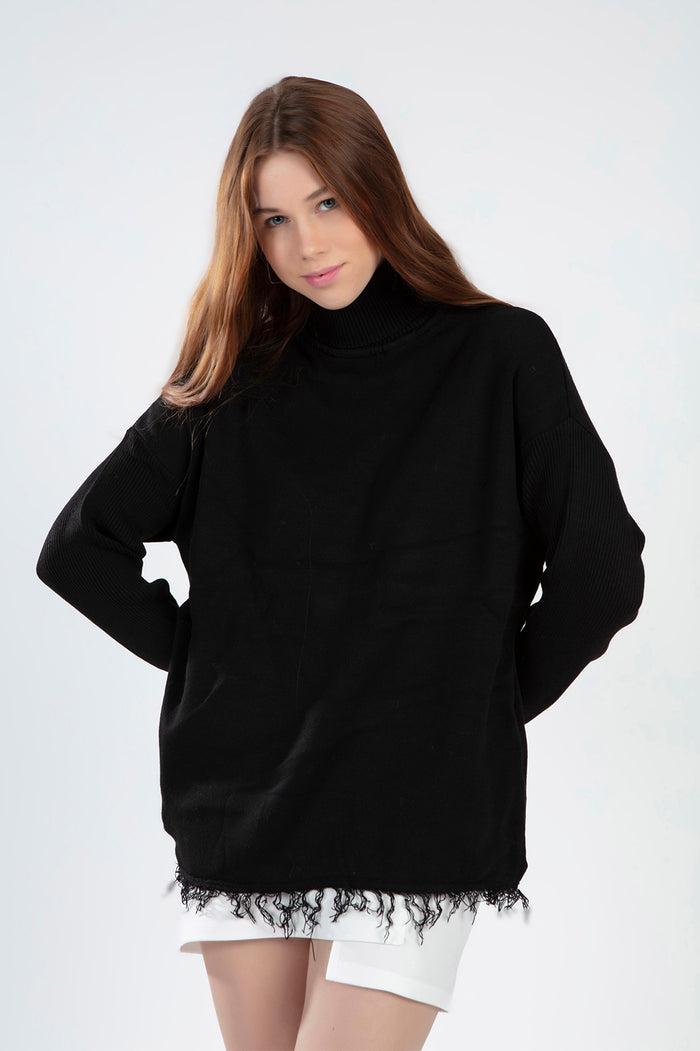 Celine black turtleneck sweater with an oversized fit and trendy distressed fringe hem on a female model.