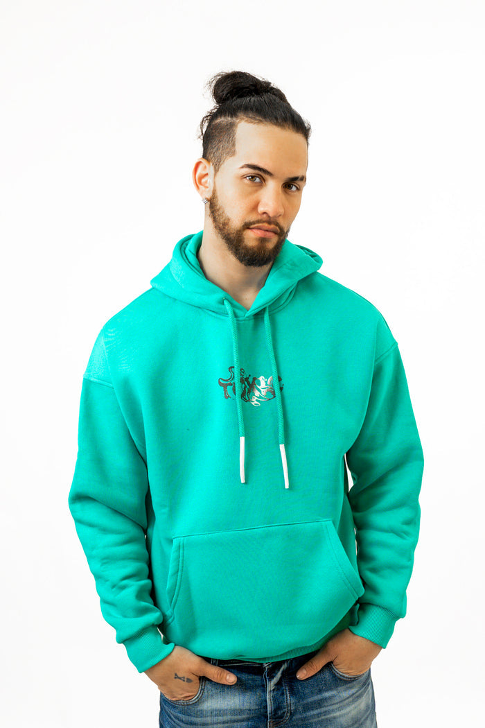 Man wearing Charles mint green oversized hoodie with streetwear graphic and front pocket.