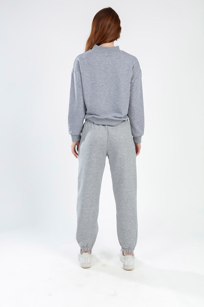Back view of the Clan grey streetwear matching set featuring a mock neck sweatshirt and relaxed-fit jogger sweatpants.