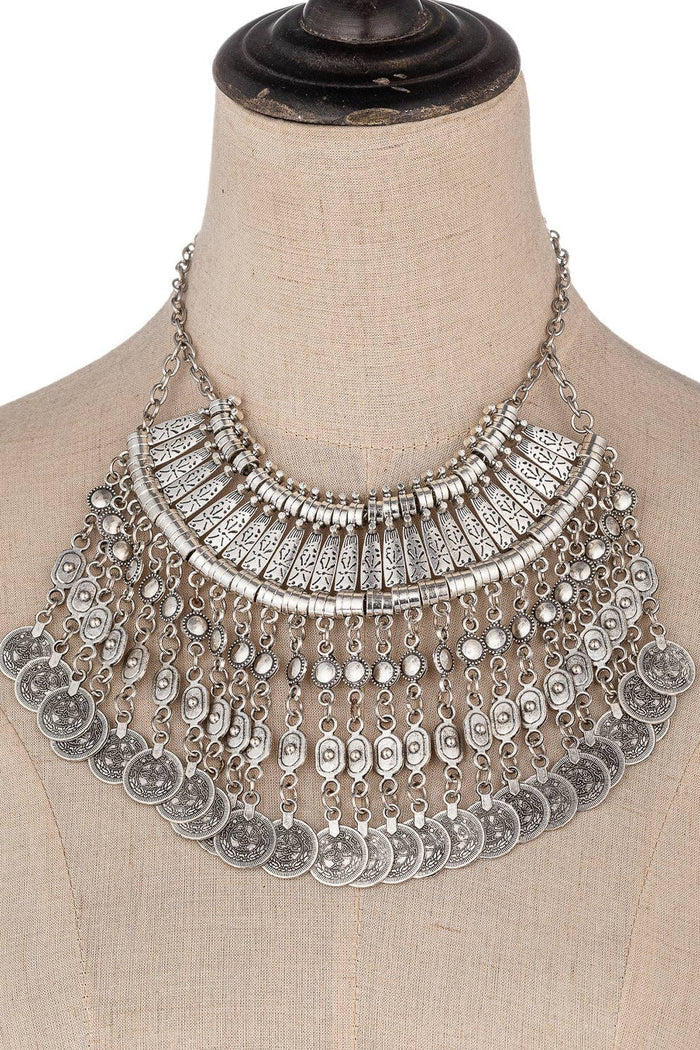Silver-tone multi-strand coin statement necklace with layered etched coin fringe and a bohemian collar shape.
