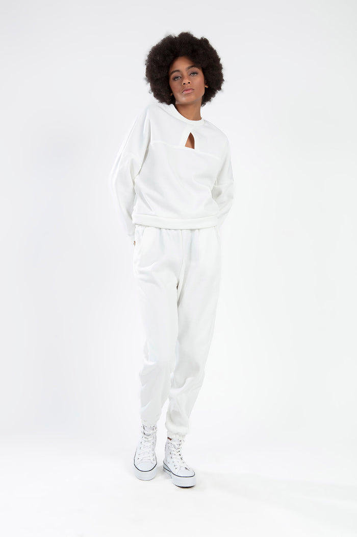 White two-piece collar sweatshirt and jogger pants set with chest cutout detail, modeled on a white background.