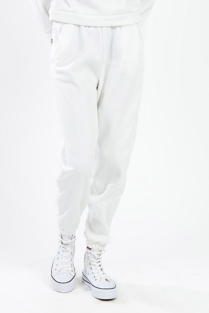Matching white two-piece collar sweatpants set with high-top sneakers, casual loungewear streetwear for women.