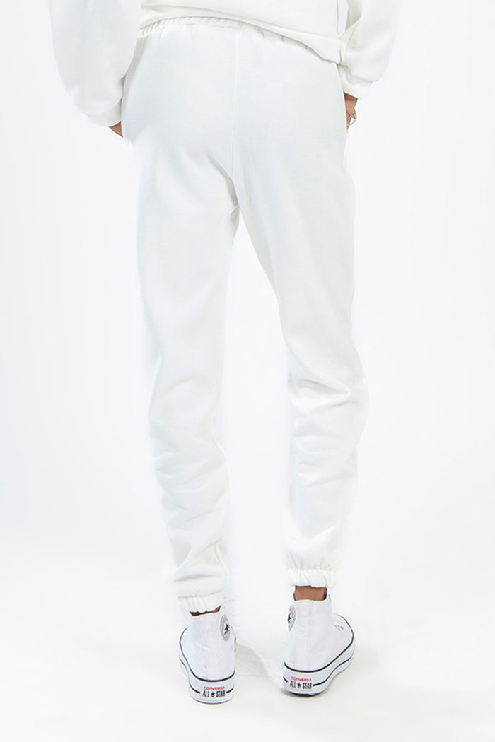 Rear view of white matching sweatpants from a two-piece set featuring an elastic waistband and jogger cuffs.