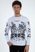Model wearing a white Constantinopolis graphic print long-sleeve shirt with Greek mythology and zodiac artwork.