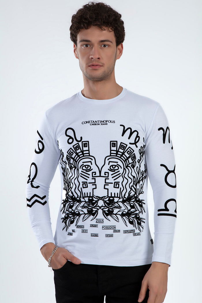 Model wearing a white Constantinopolis graphic print long-sleeve shirt with Greek mythology and zodiac artwork.