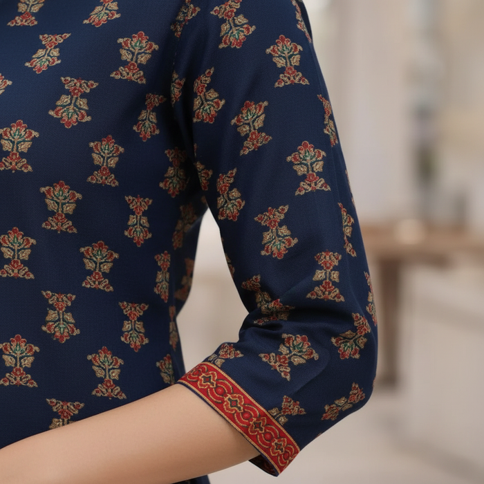 Close-up of 3/4 sleeve showing red decorative border trim at cuff