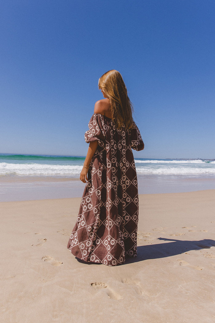 Dahlia Maxi Dress Maple — back view on beach showing billowy linen silhouette and block print pattern, ethical artisan maxi dress | Daughters of India