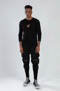 Model wearing Daniel black slim-fit streetwear cargo pants with zipper pockets and modern drawstring waist.