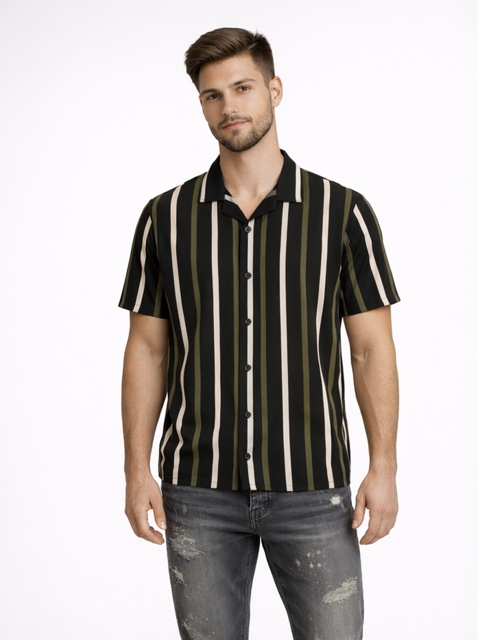 A man wearing a short-sleeve shirt with vertical black, green, and cream stripes, paired with distressed jeans.