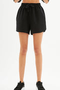 Model wearing Relaxed Fit Drawstring Sweat Shorts in Carbon black with elastic waistband and streetwear aesthetic.