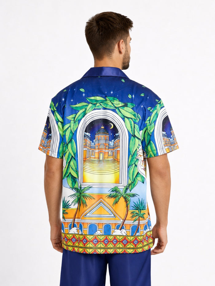 Colorful short-sleeve shirt featuring a vibrant tropical design with palm trees and architectural elements.