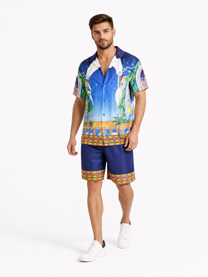 A man wearing a colorful short-sleeve shirt with a vibrant graphic design and matching shorts, paired with white snea...