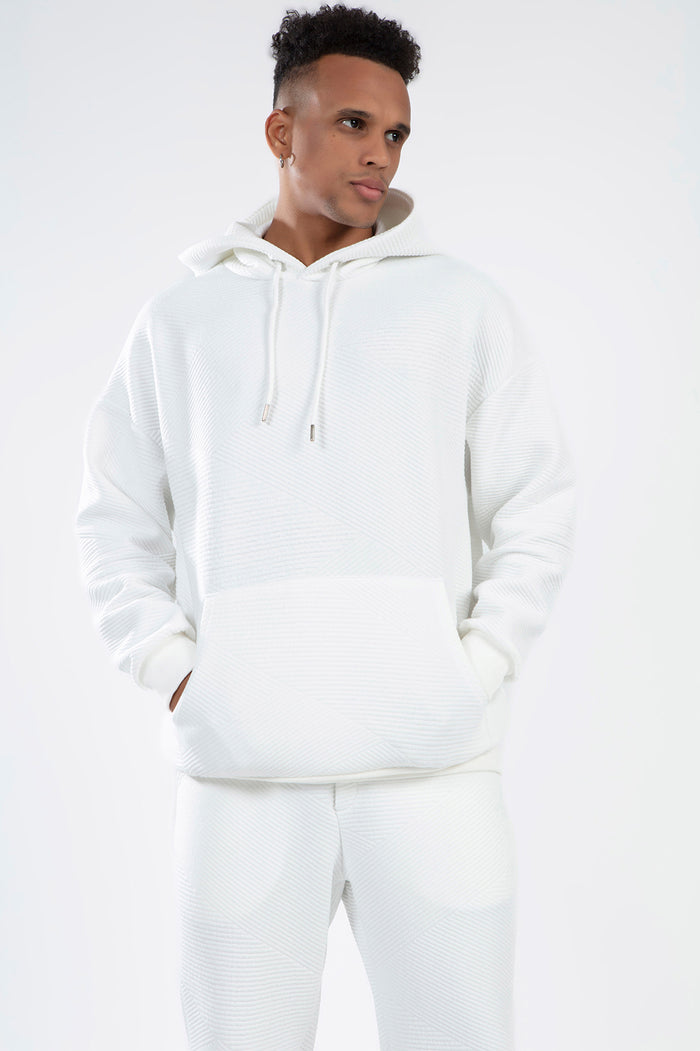 Man wearing White Eric Hoodie Set in diagonal ribbed knit fabric with a streetwear aesthetic and kangaroo pocket.