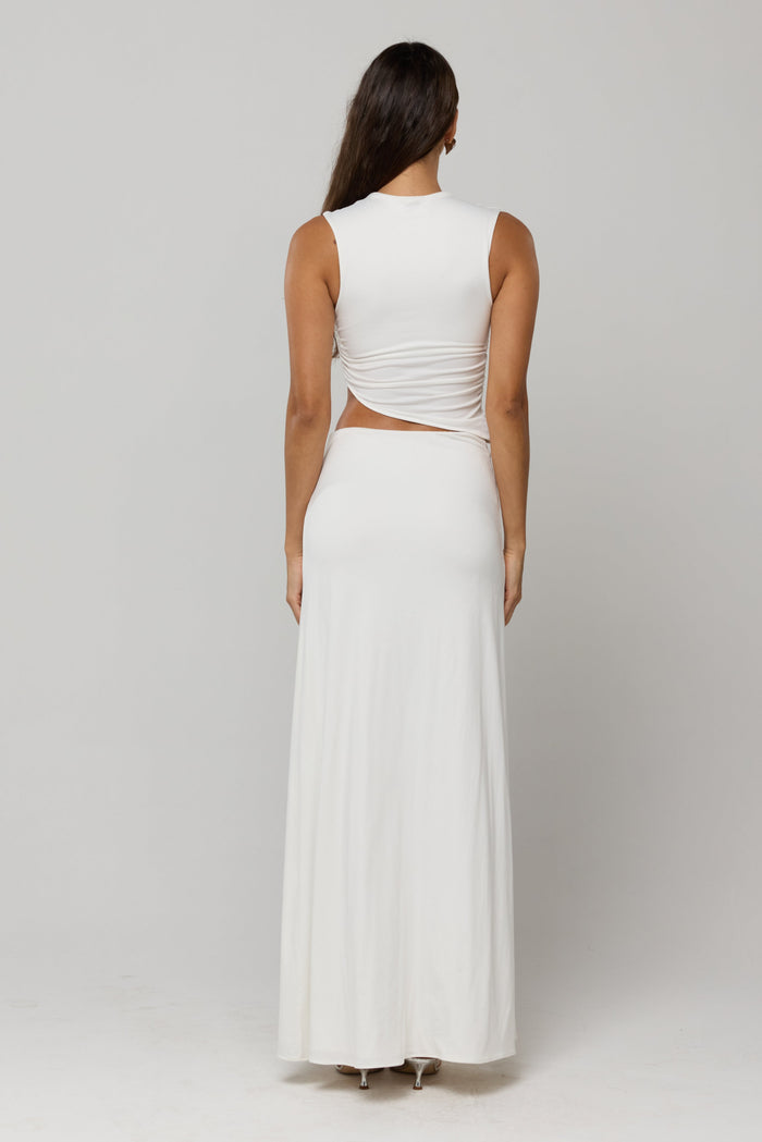This is an image of Estelle Skirt in White Knit - RESA featuring a model wearing the dress