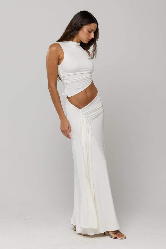 This is an image of Estelle Skirt in White Knit - RESA featuring a model wearing the dress