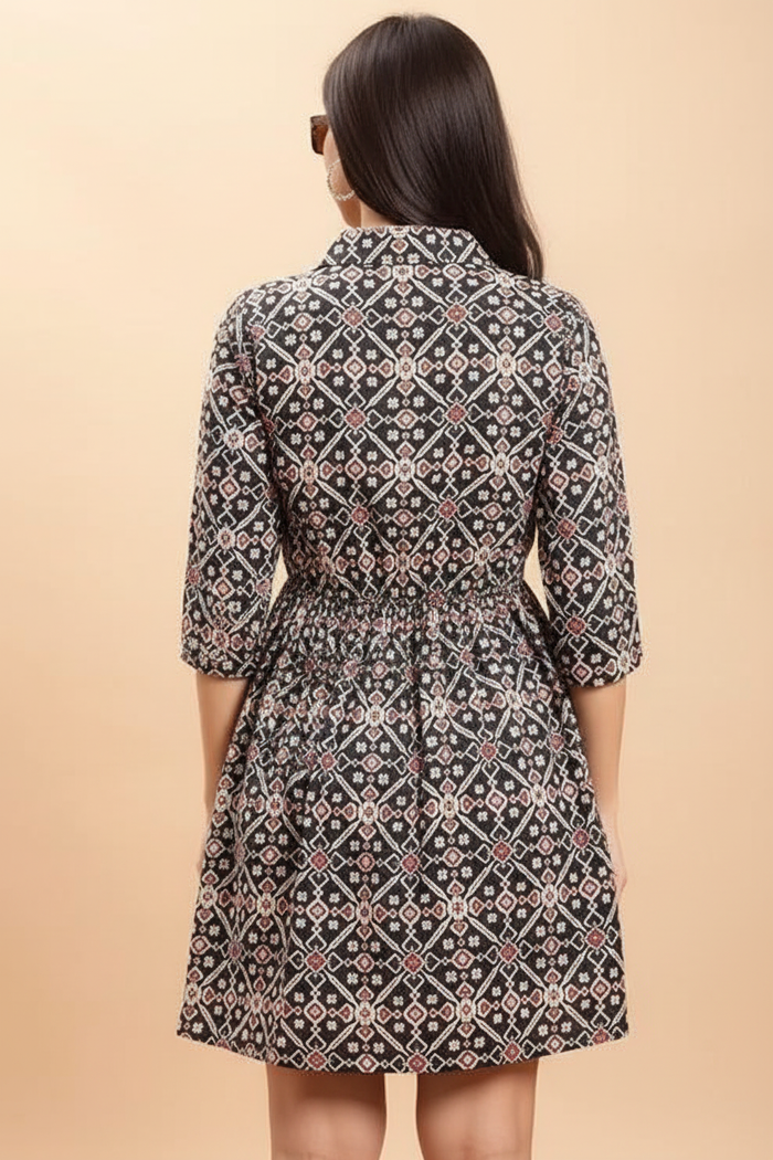 Geometric print dress back view showing gathered waist and flowing skirt