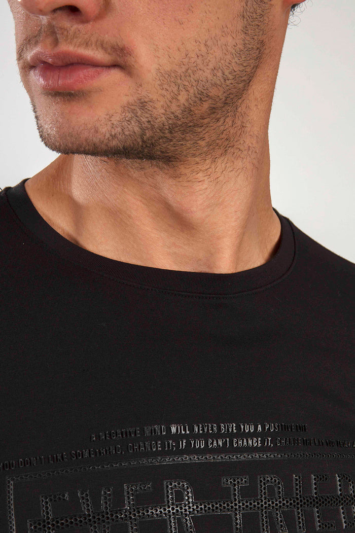 Close-up of the Ever Tried black crew neck shirt featuring embossed streetwear typography and inspirational quotes.