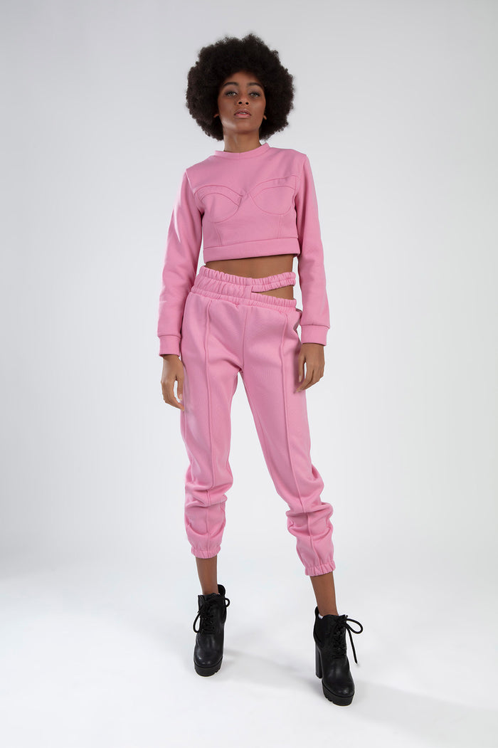 Pink Eyes Graphic Print 2-piece streetwear set with cropped long-sleeve top and cutout jogger pants on model.