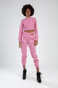 Pink Eyes Graphic Print 2-piece streetwear set with cropped long-sleeve top and cutout jogger pants on model.