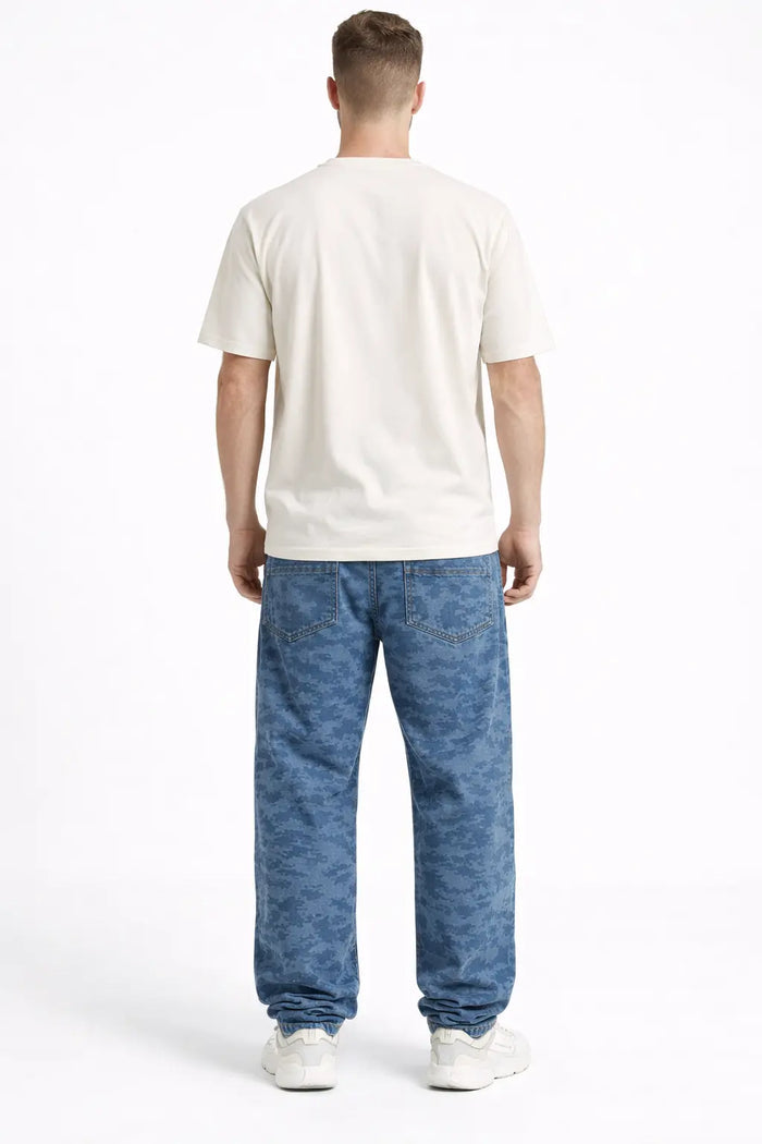 A person wearing a light-colored t-shirt and blue camo-patterned pants, viewed from the back.