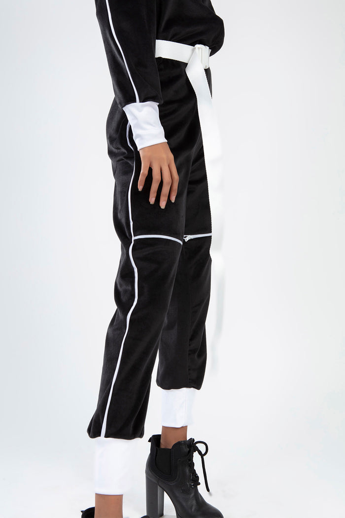 Finaley black velvet romper for women featuring white contrast piping, a belted waist, and trendy streetwear design.