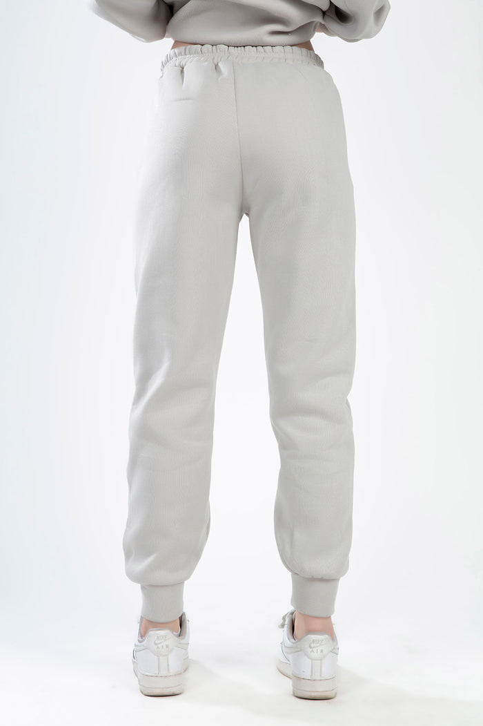 Back view of the Freya light grey lounge pants with an elastic waistband and ribbed cuffs from a matching two-piece set.