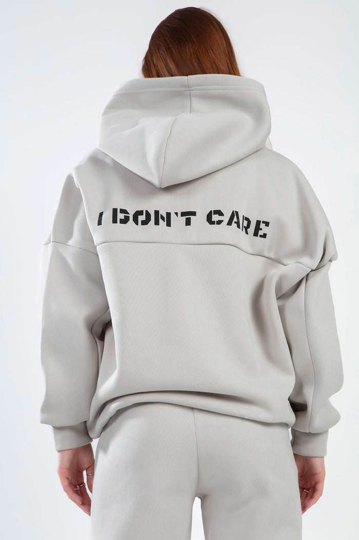Back view of the Freya light grey hoodie set featuring black 'I DON'T CARE' text on the sweatshirt for a trendy urban look.