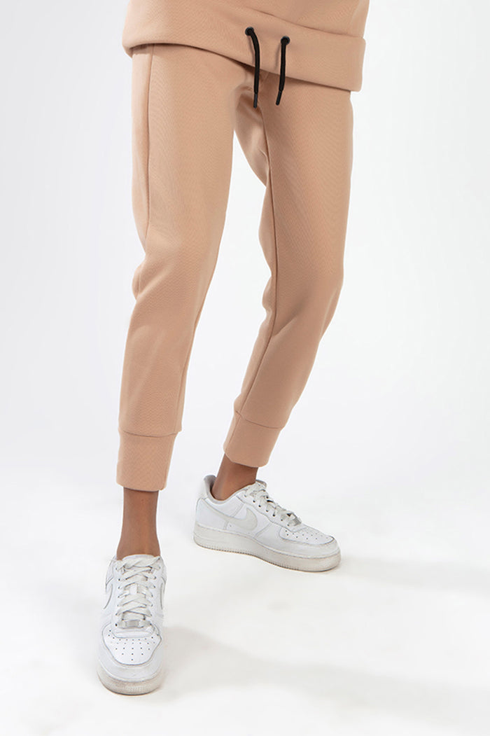 Furry Pants Set in Wild Mushroom tan textured fabric featuring slim-fit joggers with ribbed cuffs and white sneakers.