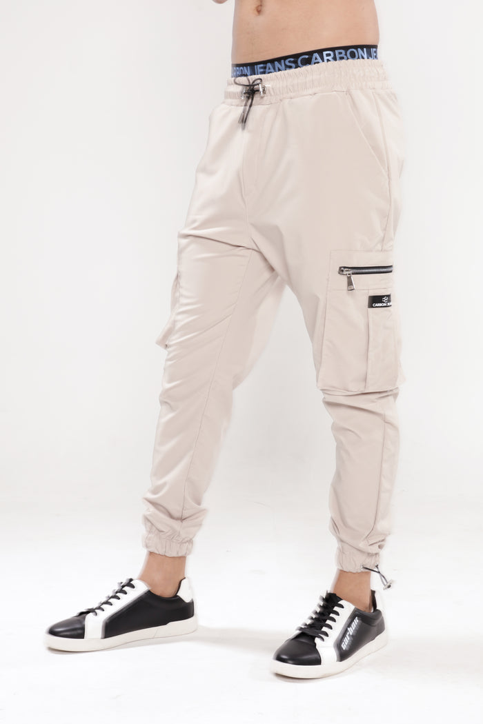 Men’s Gary Cargo Pants in stone with side zipper pockets, drawstring waist, and cuffed ankles for urban streetwear style.