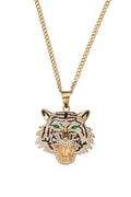 Gold chunky chain necklace with an oversized tiger head pendant featuring crystal embellishments and green stone eyes.