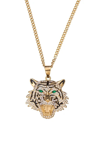 Gold chunky chain necklace with an oversized tiger head pendant featuring crystal embellishments and green stone eyes.