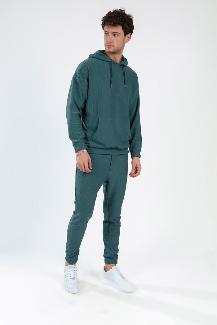 Man wearing the Gordon carbon ribbed matching set featuring a hoodie and joggers in a turquoise urban streetwear style.
