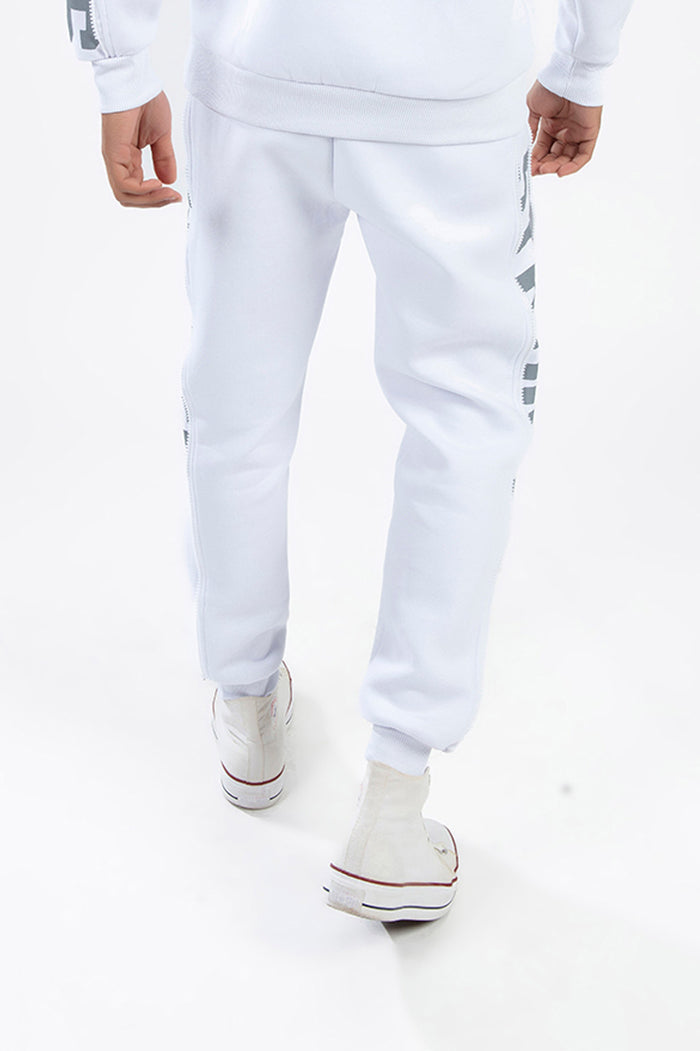 Rear view of white Ian Matching Pants Set streetwear joggers with gray side graphics, side zippers, and cuffed ankles.