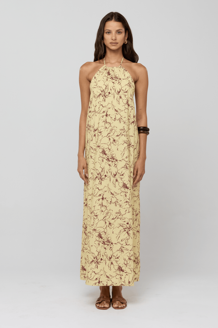 This is an image of Iris Halter Dress in Butterscotch - RESA featuring a model wearing the dress
