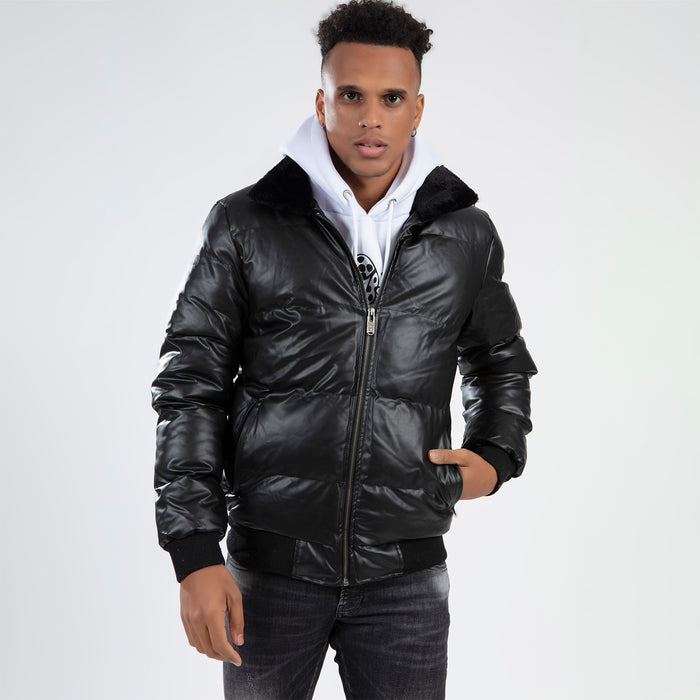 Man in Jerry Puffer Coat, a black insulated jacket with fur collar, worn over a white hoodie for winter street style.
