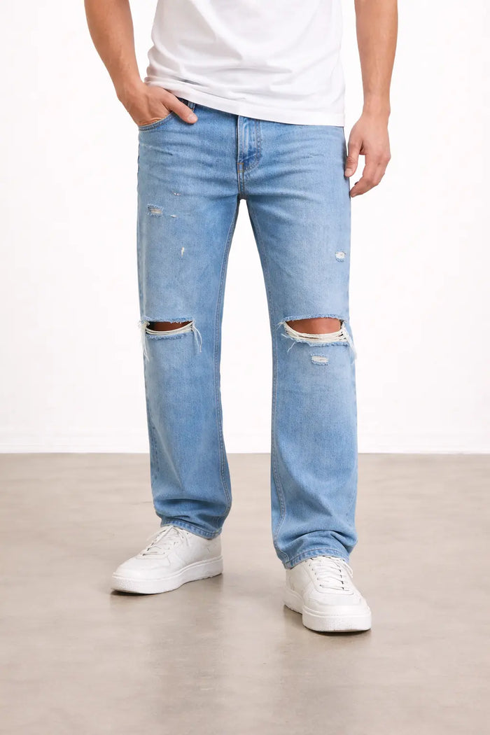 Light blue distressed jeans with ripped knees, paired with a white t-shirt and white sneakers.