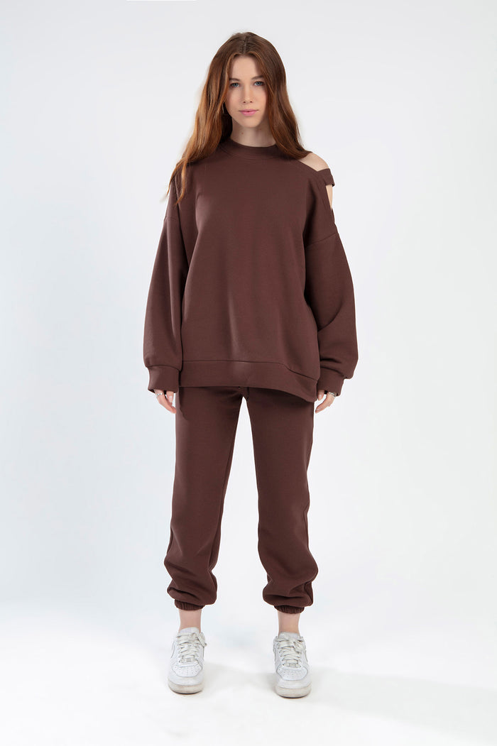 Model wearing Jolene burgundy two-piece set featuring cold-shoulder sweatshirt and matching joggers.