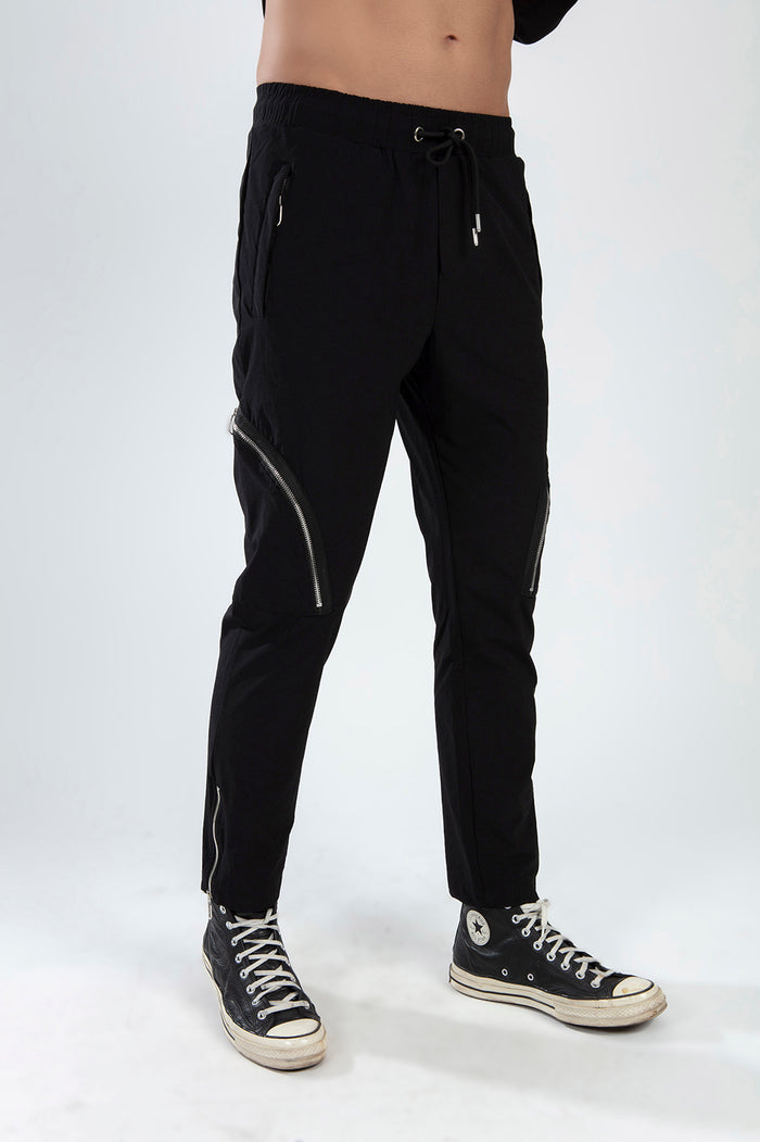 Men's black Kent streetwear pants with drawstring waist, side zip cargo pockets, and ankle zippers.