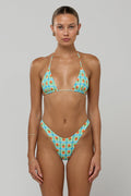 This is an image of Kyle Triangle Bikini Top in Juicy - RESA featuring a model wearing the dress