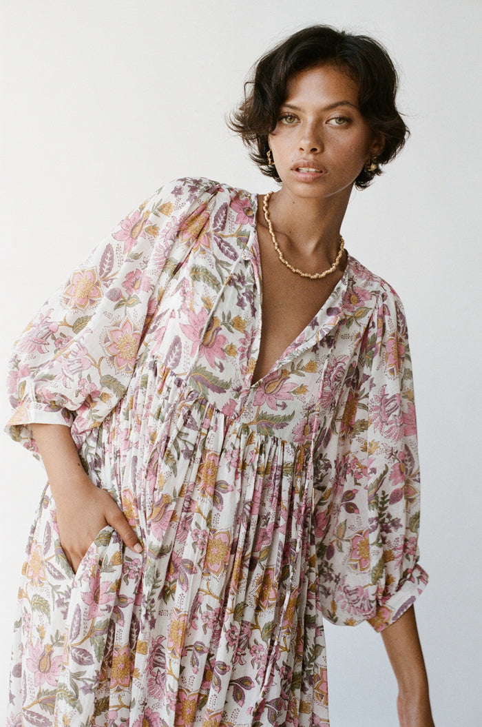 Daughters of India Kyra Maxi Dress in Fuchsia Bloom — studio close-up V-neckline, hand in pocket, gold necklace