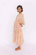 Daughters of India Kyra Midi Dress in Apricot Blush — studio side profile, billowed sleeves and gathered waist, hand screen print cotton